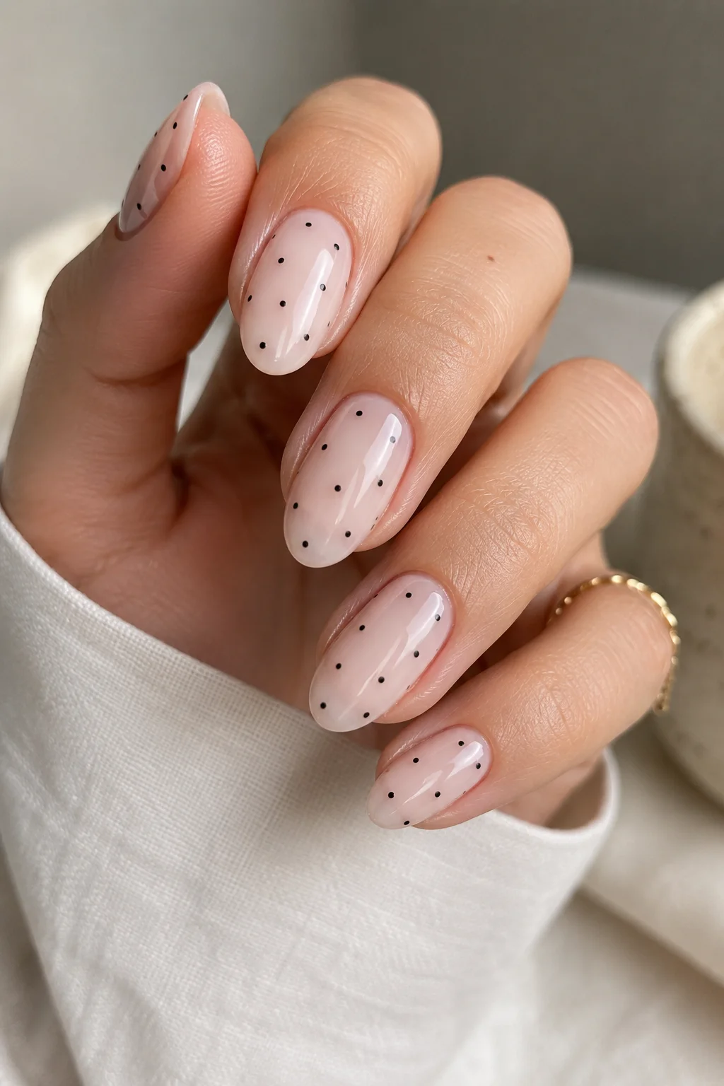 micro polka dot nails tiny black dots scattered asymmetrically on sheer milky base minimal clean 2026