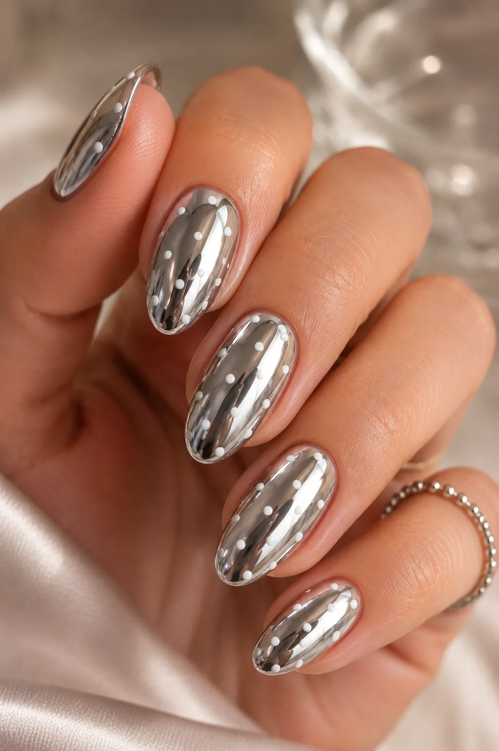 chrome base polka dot nails silver mirror chrome with small white dots on sealed surface dimensional 2026