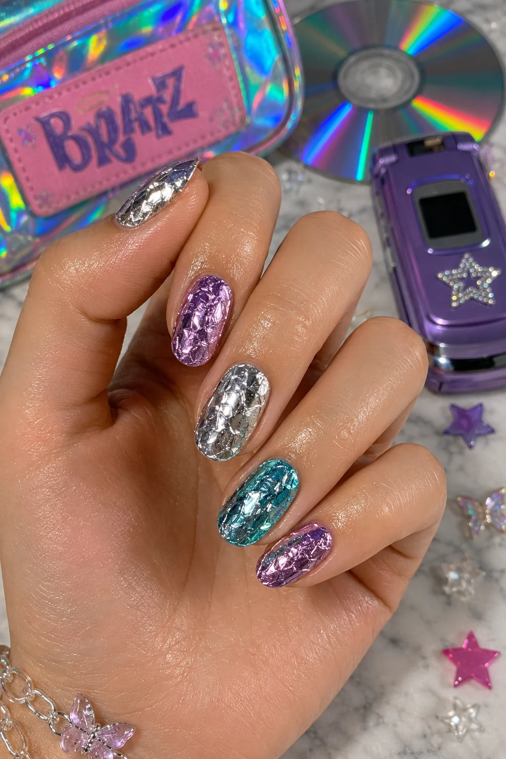 Y2K foil nails metallic foil transfer crinkled texture silver purple over gel base 2026